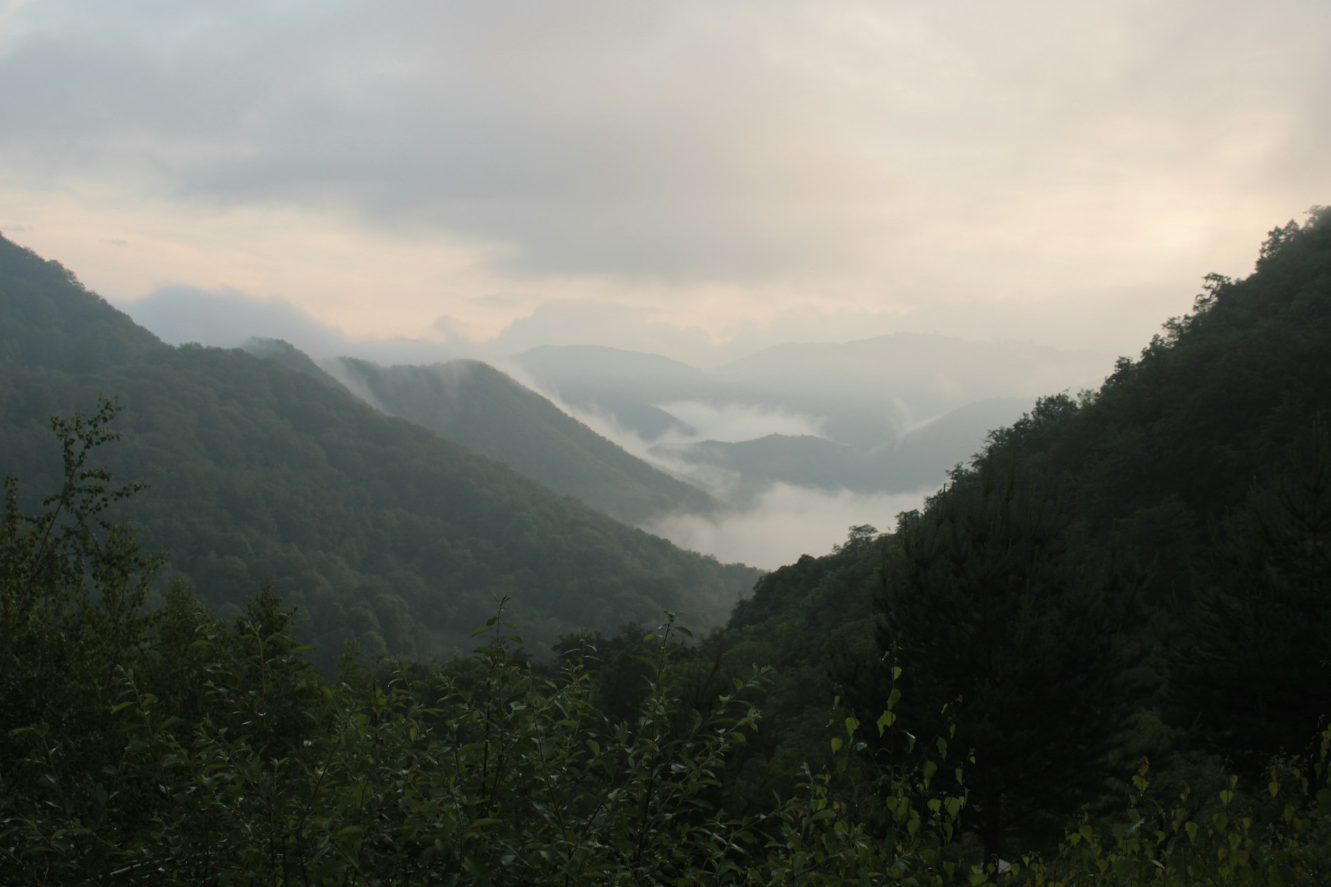 a view of a mountain range with low lying clouds